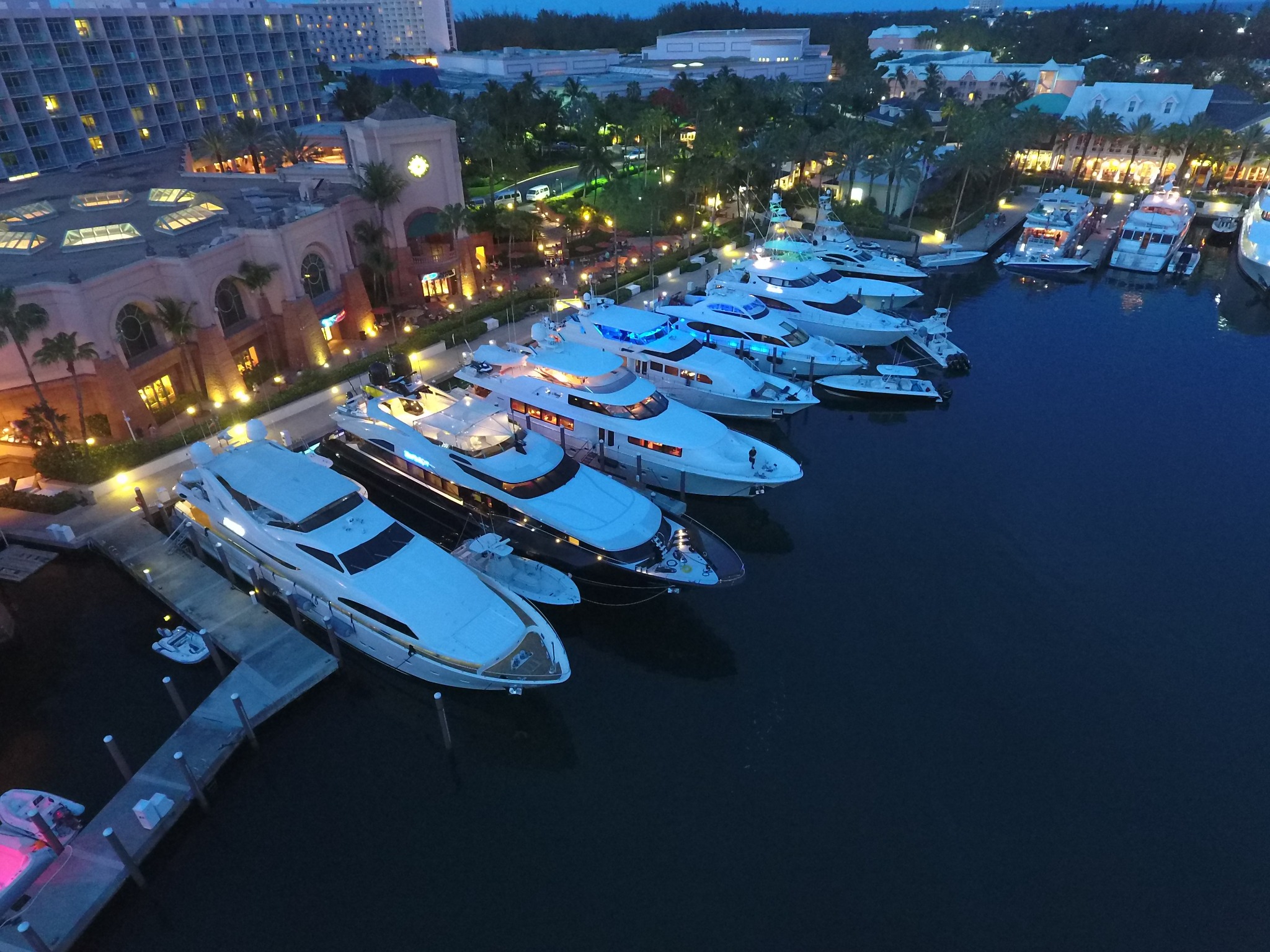 Motor yachts berthed at Atlantis marina after dark